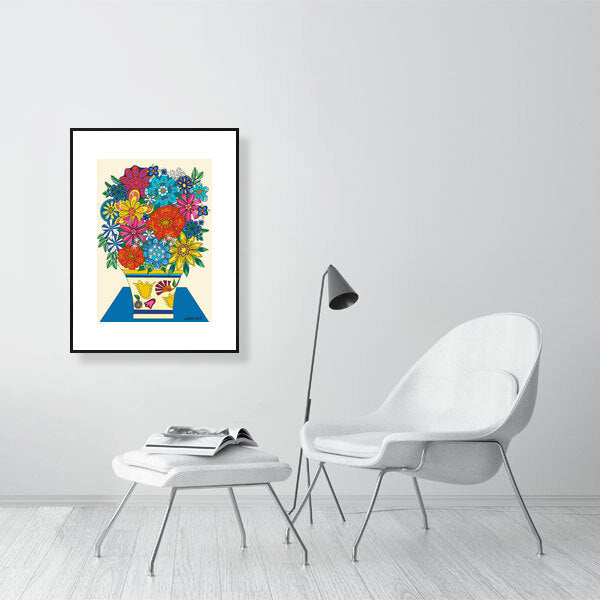 Framed colorful artwork of flowers on a wall in a modern room with a chair and lamp.
