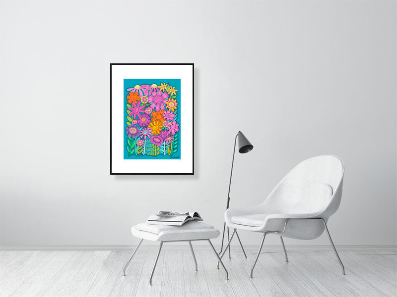Framed floral artwork on a white wall above a modern chair and table.