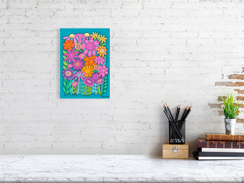 Colorful floral artwork on a white brick wall above a desk.