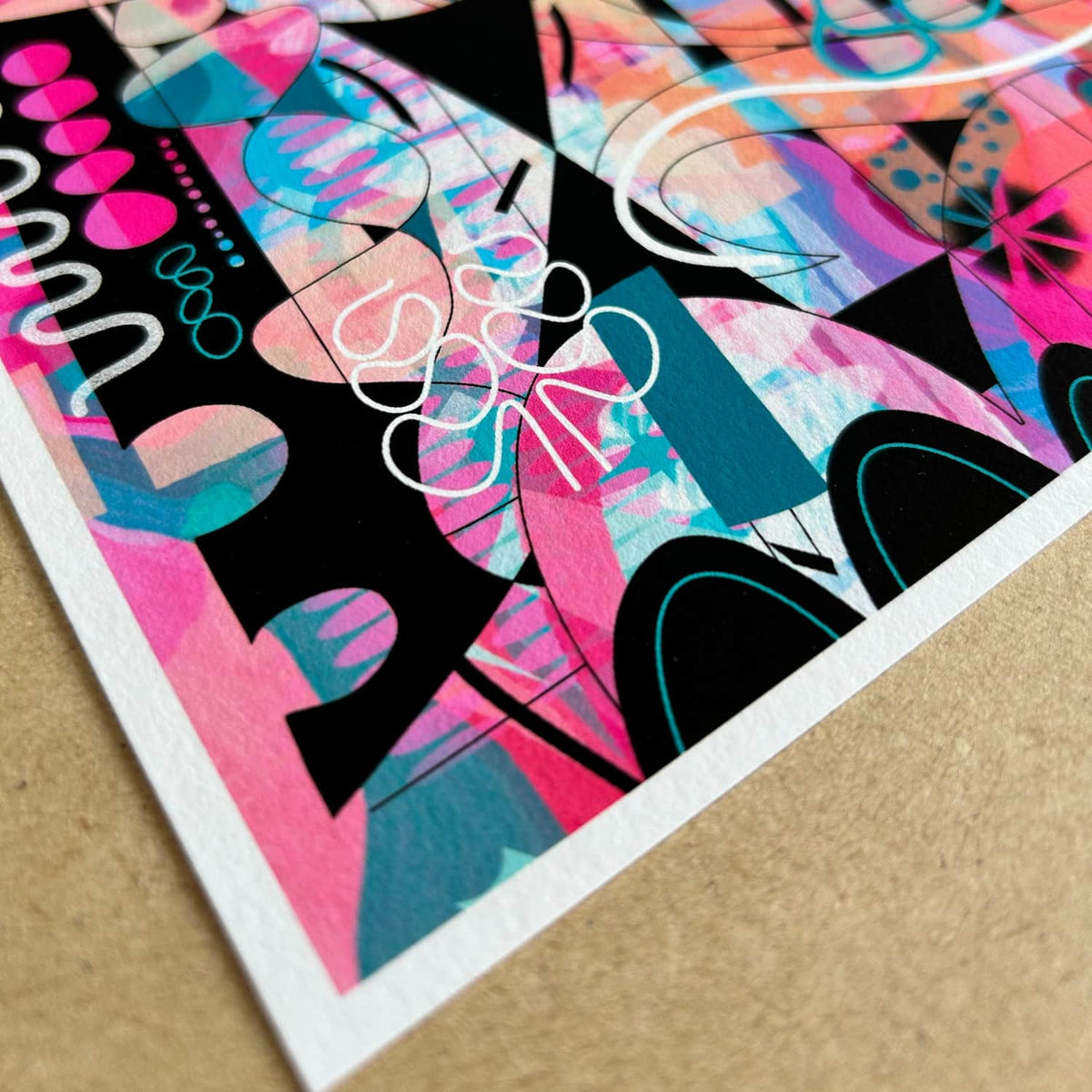 A close-up detail of a giclée fine art print called ‘Just Lovely’- created from an original digitally painted  abstract artwork by Uk artist Ruth Dronsfield. The image shows details in pink, teal and orange with black and white elements. The closeup shows the paper has a rough texture like watercolour paper
