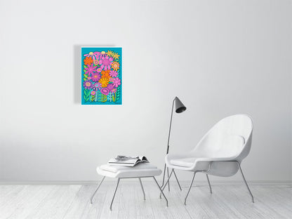 Colorful floral wall art on a white wall above a white chair and ottoman.