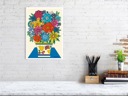Colorful floral artwork on a white brick wall above a desk.