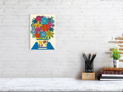 Colorful floral artwork on a white brick wall above a desk.