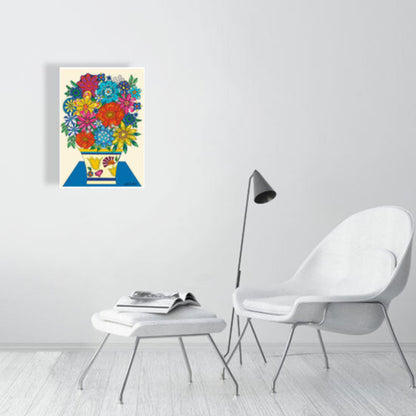 Colorful floral artwork on a white wall above a white chair and ottoman.