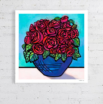 Unframed artwork of red roses in a blue vase on a white brick wall. Deep red coloured roses in cobalt blue bowl with a turquoise background. Modern style with strong black line work 