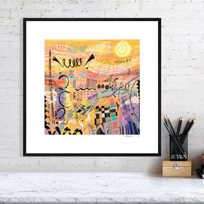 A framed limited edition abstract art print titled 'Sunburst' by Ruth Dronsfield. The vibrant yellow and orange print is professionally mounted and displayed in a clean, modern black  frame, hanging on a white brick wall above a styled marble desk.