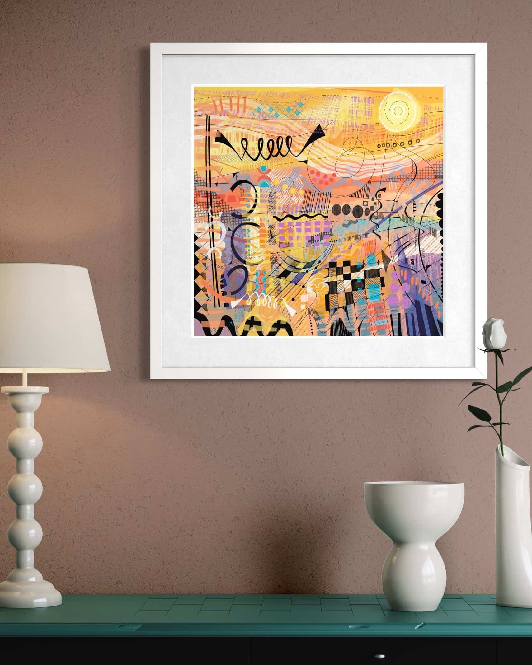 Framed Sunburst art print by UK artist Ruth Dronsfield. On a wall above a green cabinet with decorative items.