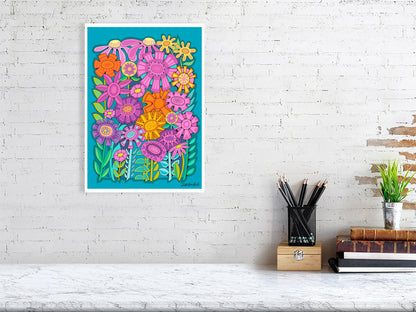 Colorful floral artwork on a white brick wall with a desk and books in the foreground.