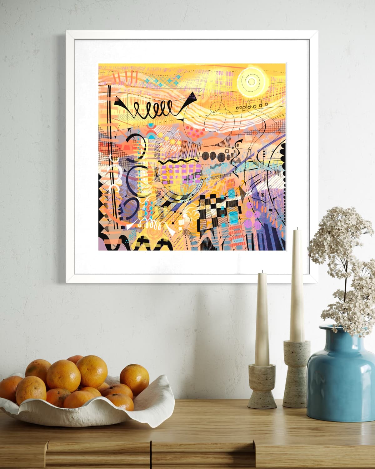Framed Sunburst limited edition art print by UK artist Ruth Dronsfield. On a wall above a wooden console table with decorative items.