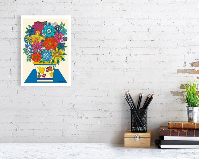 Colorful floral Vintage Vibes Bouquet by UK artist Ruth Dronsfield. On a white brick wall above a desk with stationery items.